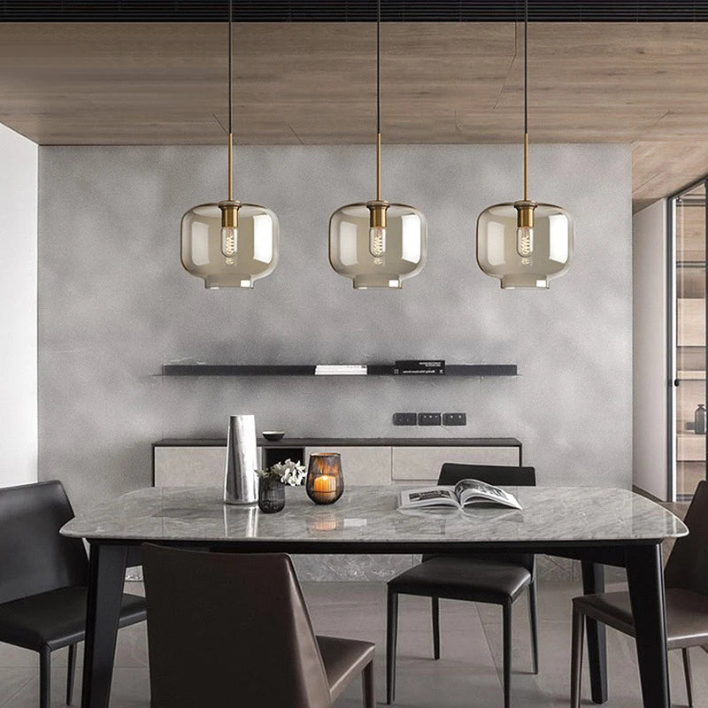 Nordic glass pendant light suspended above a kitchen island in a modern Scandinavian-inspired home.