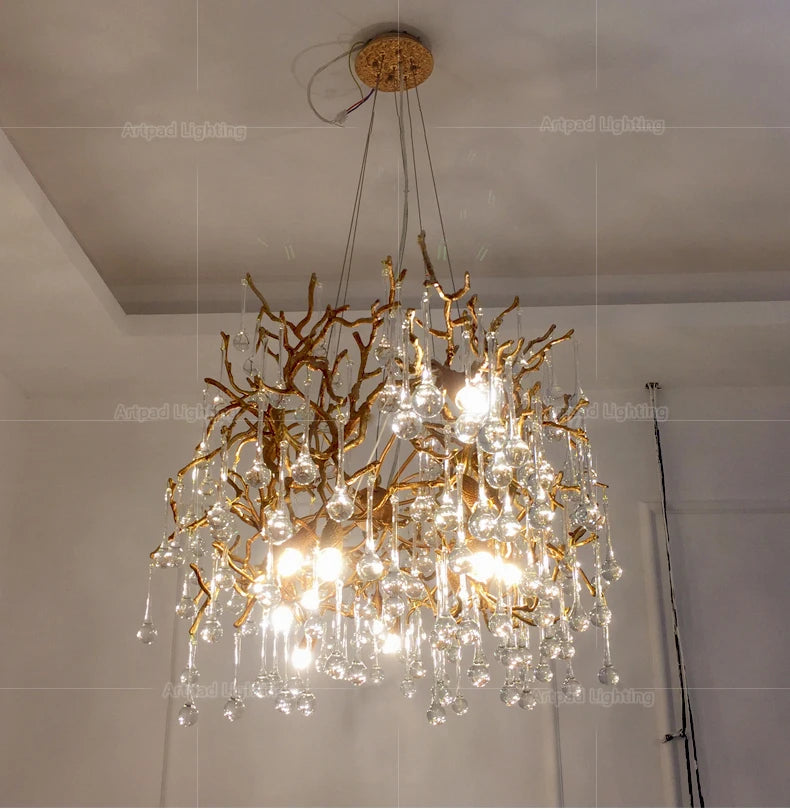 Luxury gold branch crystal chandelier hanging in a modern living room with elegant contemporary décor.