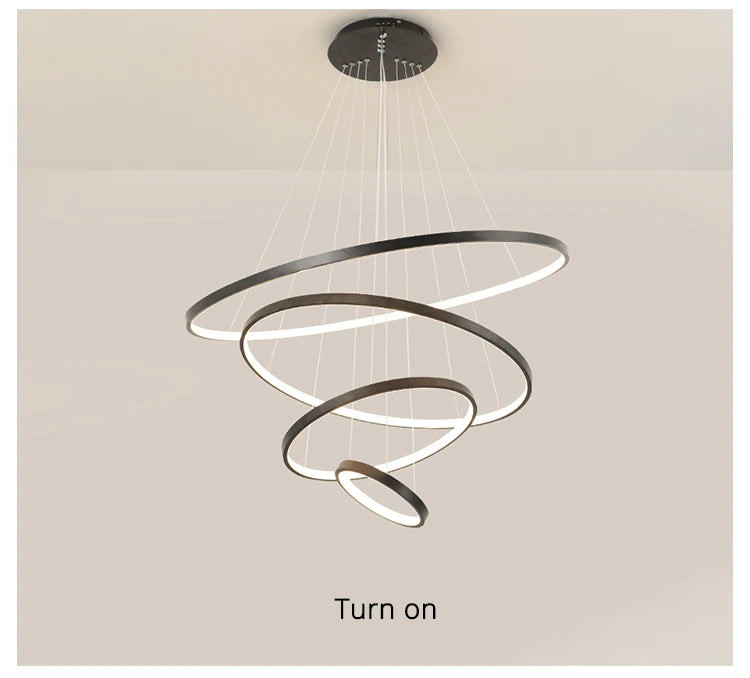 Modern LED ring chandelier suspended above a dining table in a luxury contemporary home.