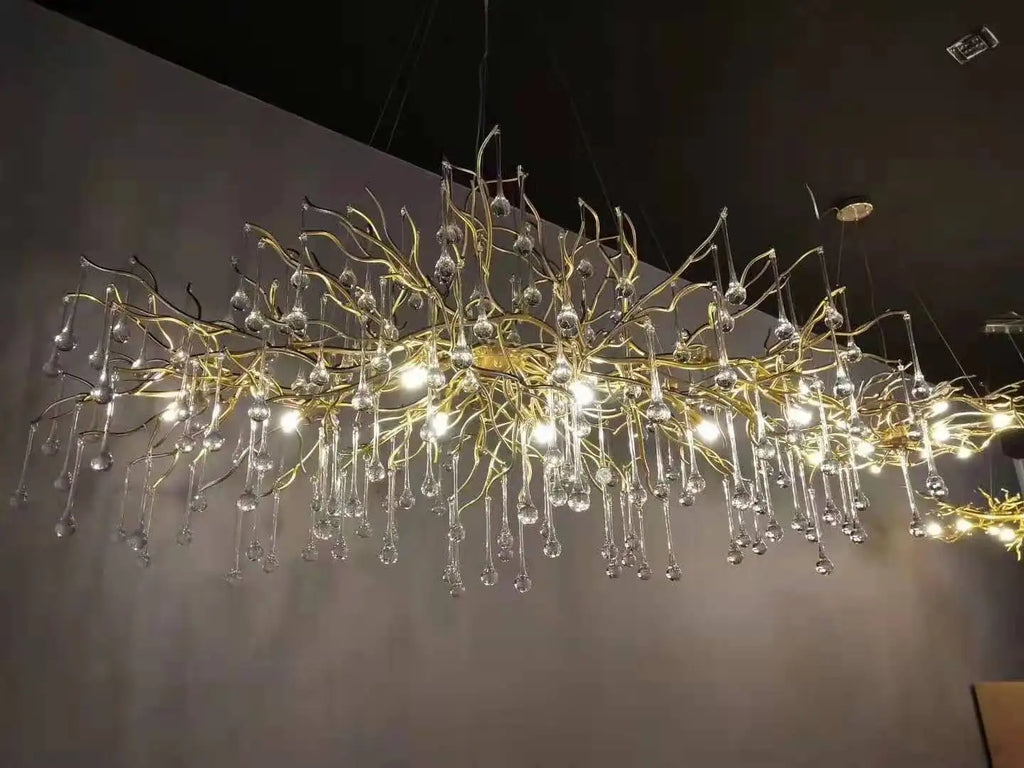 Luxury gold branch crystal chandelier hanging in a modern living room with elegant contemporary décor.