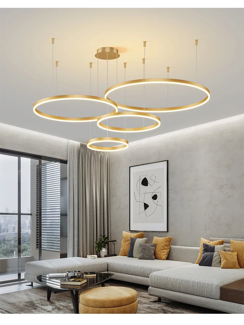 Modern LED circular ring chandelier installed above a dining table in a contemporary luxury home.