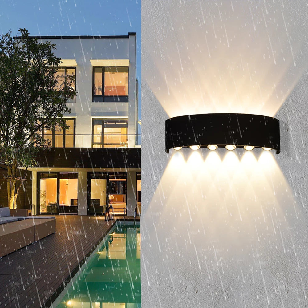 Modern waterproof LED wall light installed on an exterior house wall illuminating a porch and garden.