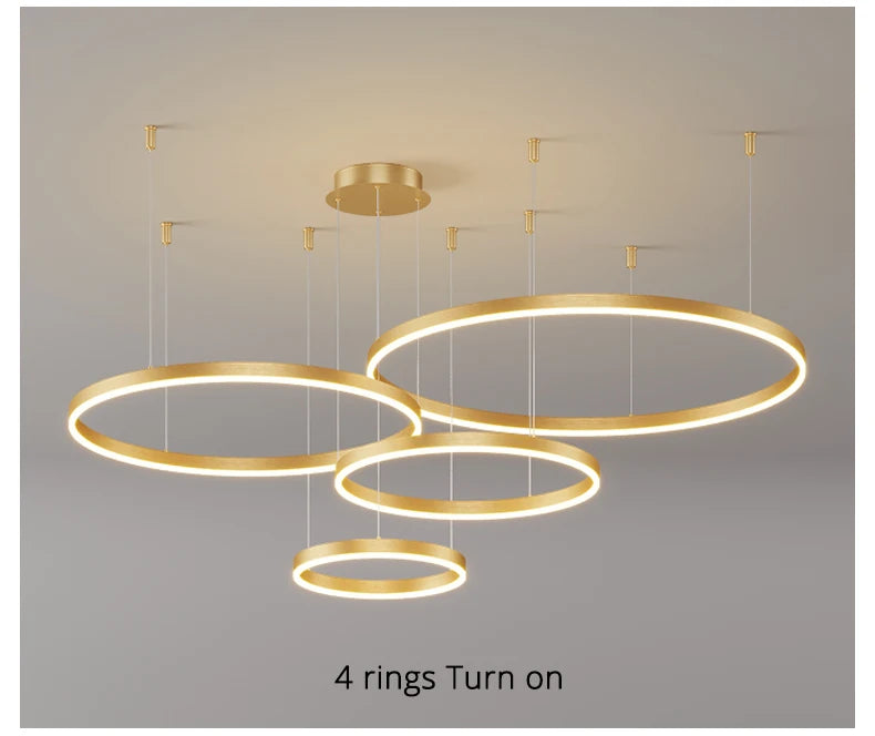 Modern LED circular ring chandelier installed above a dining table in a contemporary luxury home.
