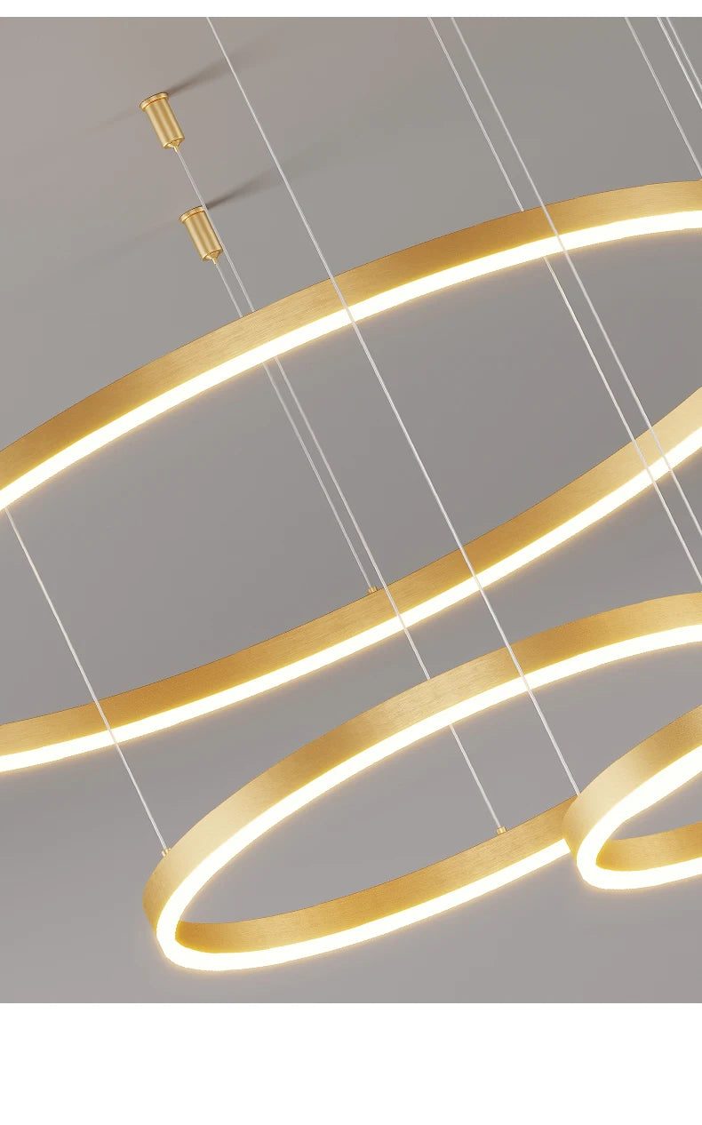 Modern LED circular ring chandelier installed above a dining table in a contemporary luxury home.