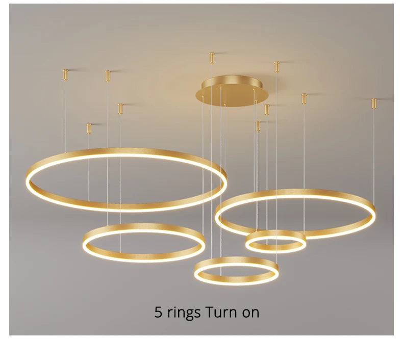 Modern LED circular ring chandelier installed above a dining table in a contemporary luxury home.