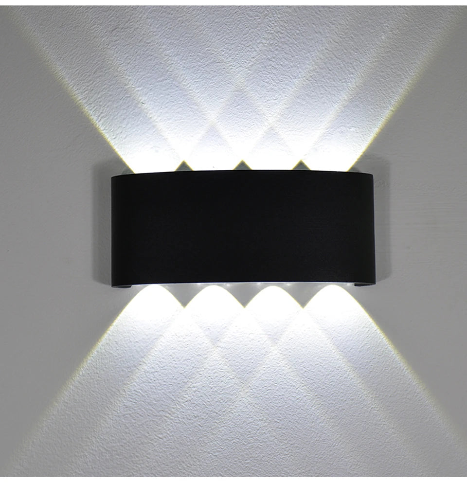 Modern waterproof LED wall light installed on an exterior house wall illuminating a porch and garden.