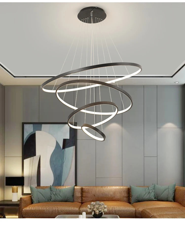 Modern LED ring chandelier suspended above a dining table in a luxury contemporary home.