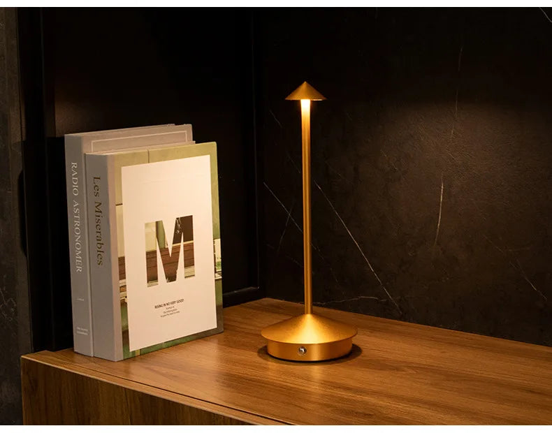Rechargeable touch LED table lamp placed on a modern dining table in a stylish café-inspired interior.