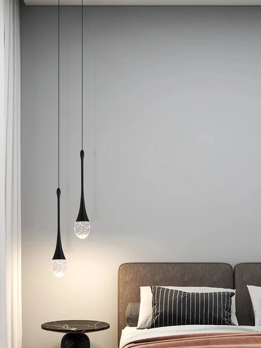Modern bubble crystal pendant light hanging above a kitchen island in a luxury contemporary home.