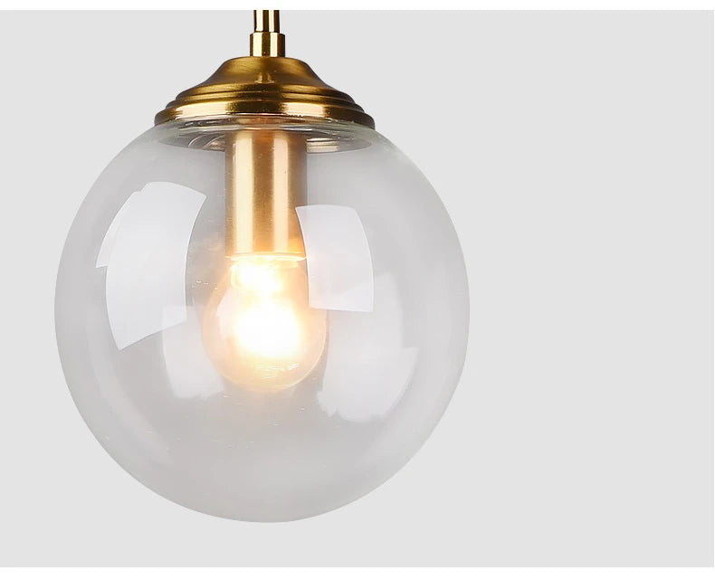 Modern luxury glass LED pendant light hanging above a dining table in a contemporary home.