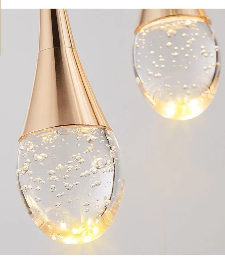 Modern bubble crystal pendant light hanging above a kitchen island in a luxury contemporary home.
