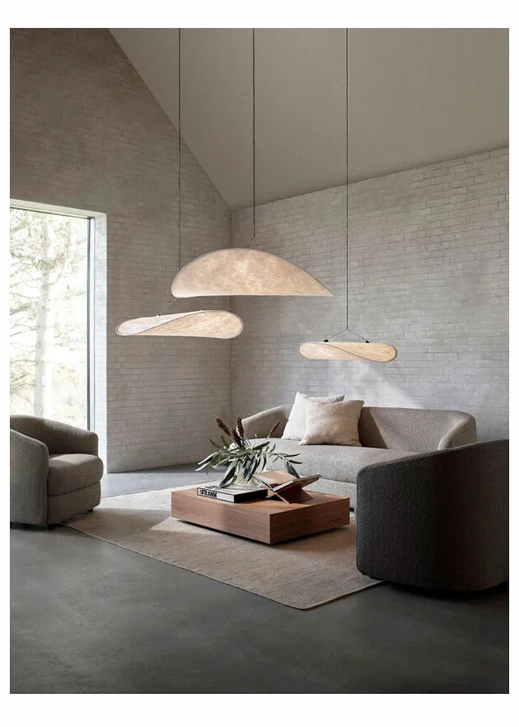 Nordic modern LED pendant light hanging above a dining table in a contemporary living room.
