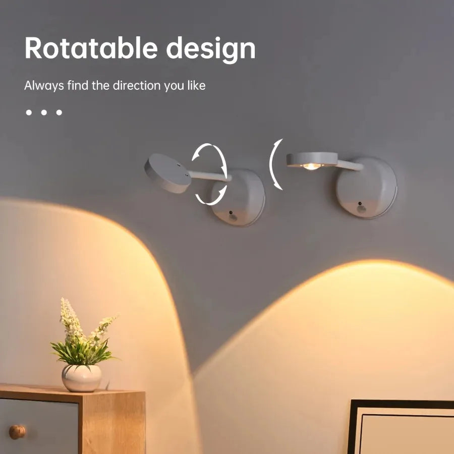 Rechargeable motion sensor LED wall light illuminating a framed artwork in a modern living room.