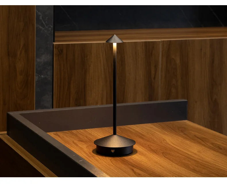 Rechargeable touch LED table lamp placed on a modern dining table in a stylish café-inspired interior.