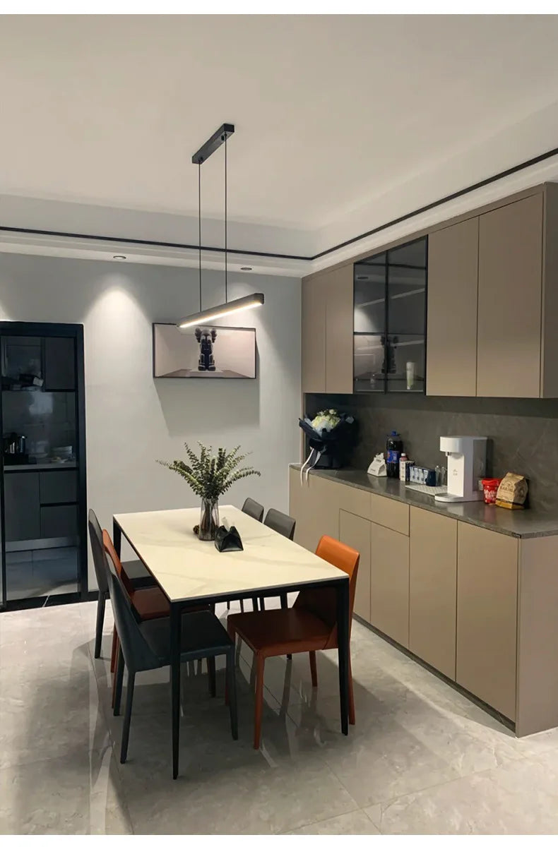 Modern Linear LED Pendant Light illuminating a contemporary dining table in a stylish kitchen.