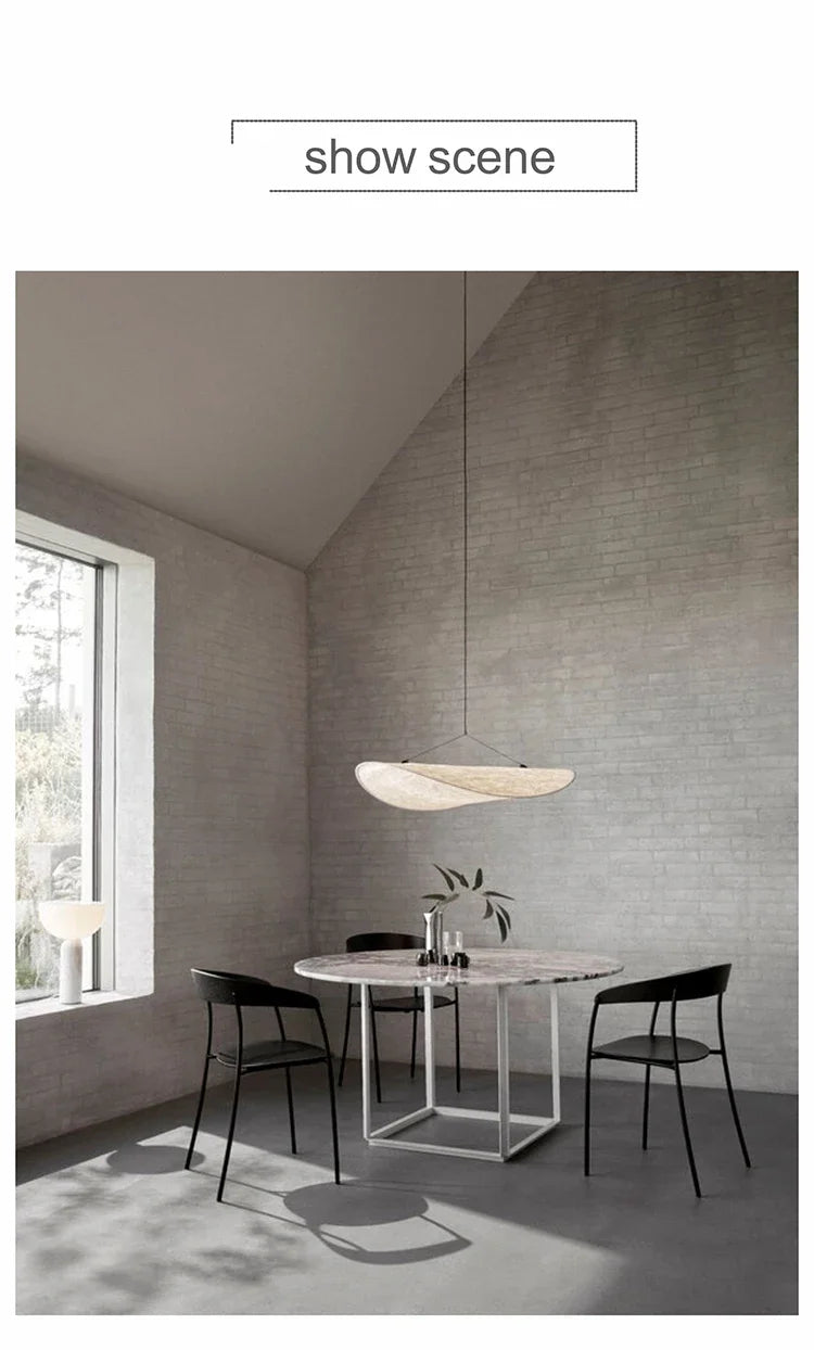 Nordic modern LED pendant light hanging above a dining table in a contemporary living room.