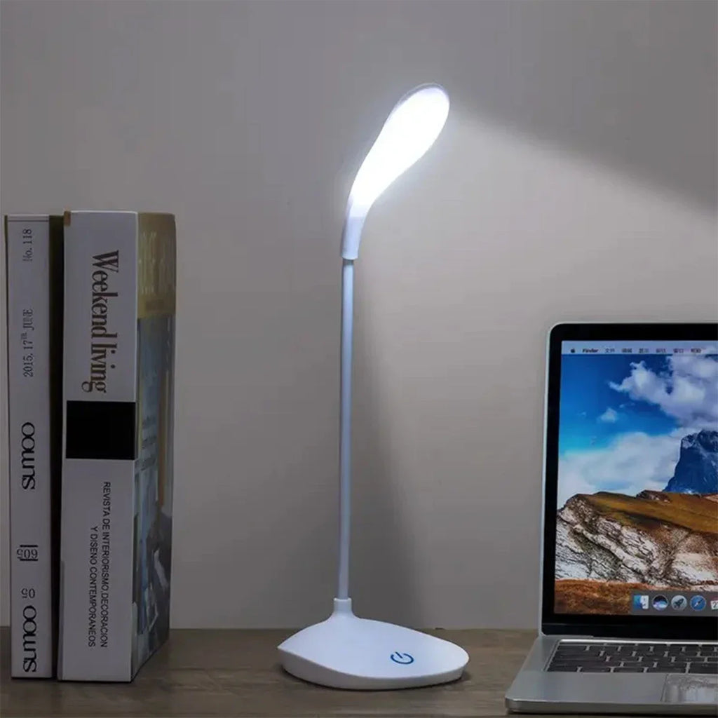 Modern LED eye care desk lamp with USB charging and touch dimming on a study desk.