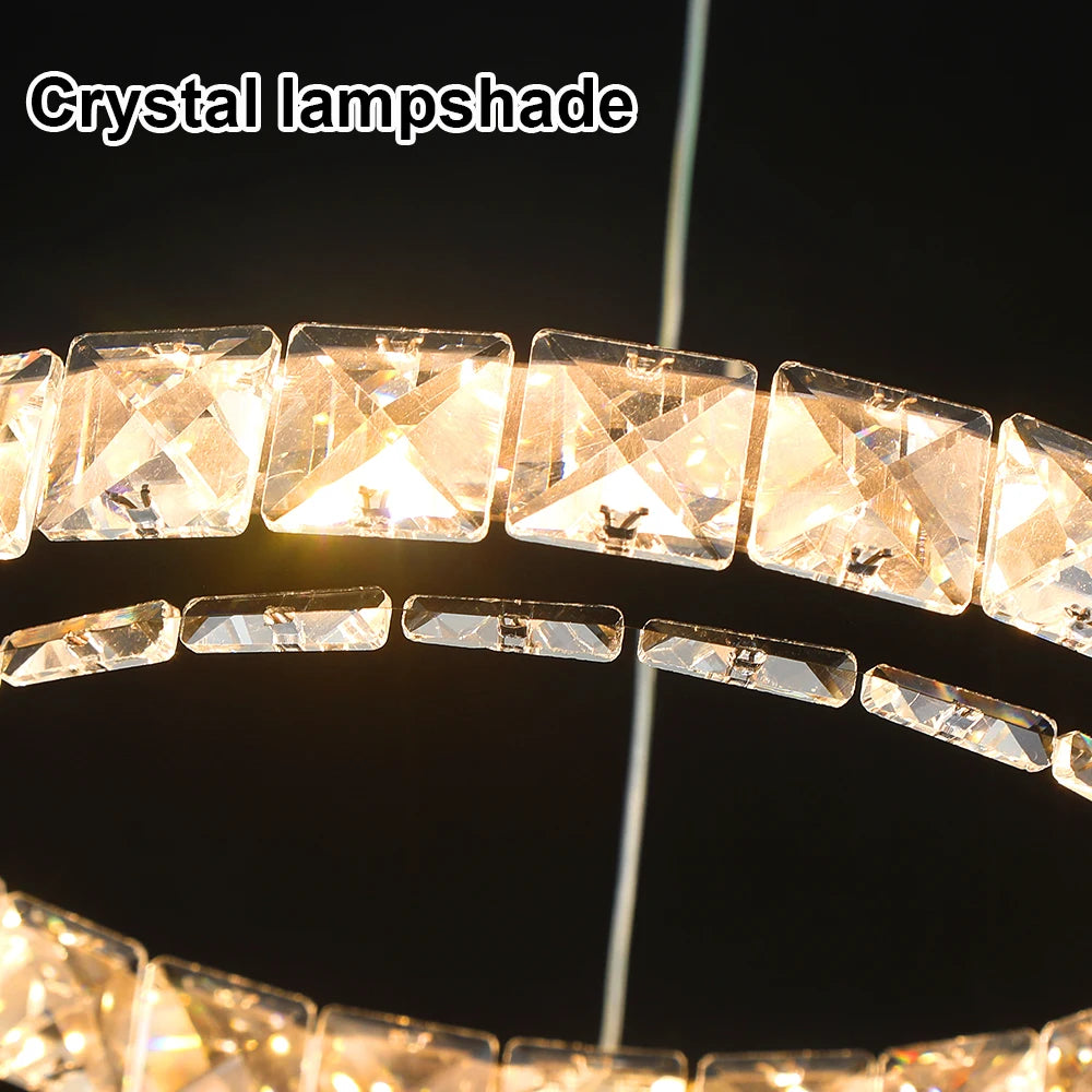 Luxury crystal ring LED chandelier suspended above a modern dining table in an elegant contemporary home.