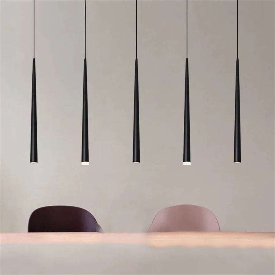 Modern cone LED pendant light hanging above a kitchen island in a contemporary home.