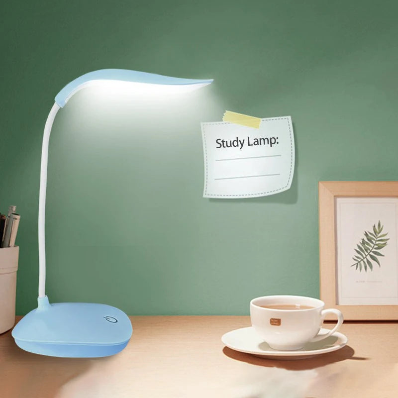 Modern LED eye care desk lamp with USB charging and touch dimming on a study desk.