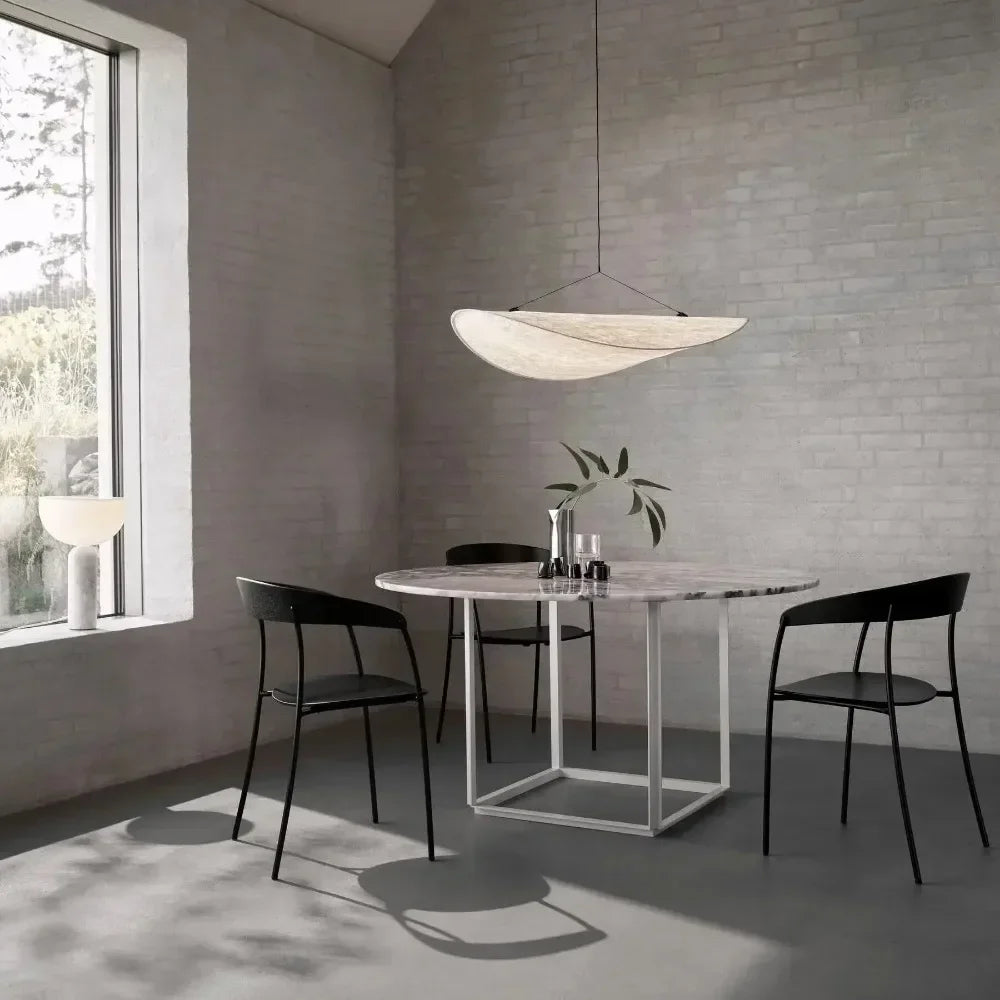 Nordic modern LED pendant light hanging above a dining table in a contemporary living room.
