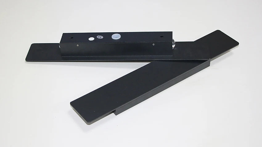 Modern black aluminum IP65 waterproof LED wall light mounted on an exterior wall with an up-and-down lighting effect.