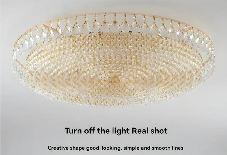 Luxury gold crystal LED chandelier hanging in an elegant modern living room with premium interior décor.
