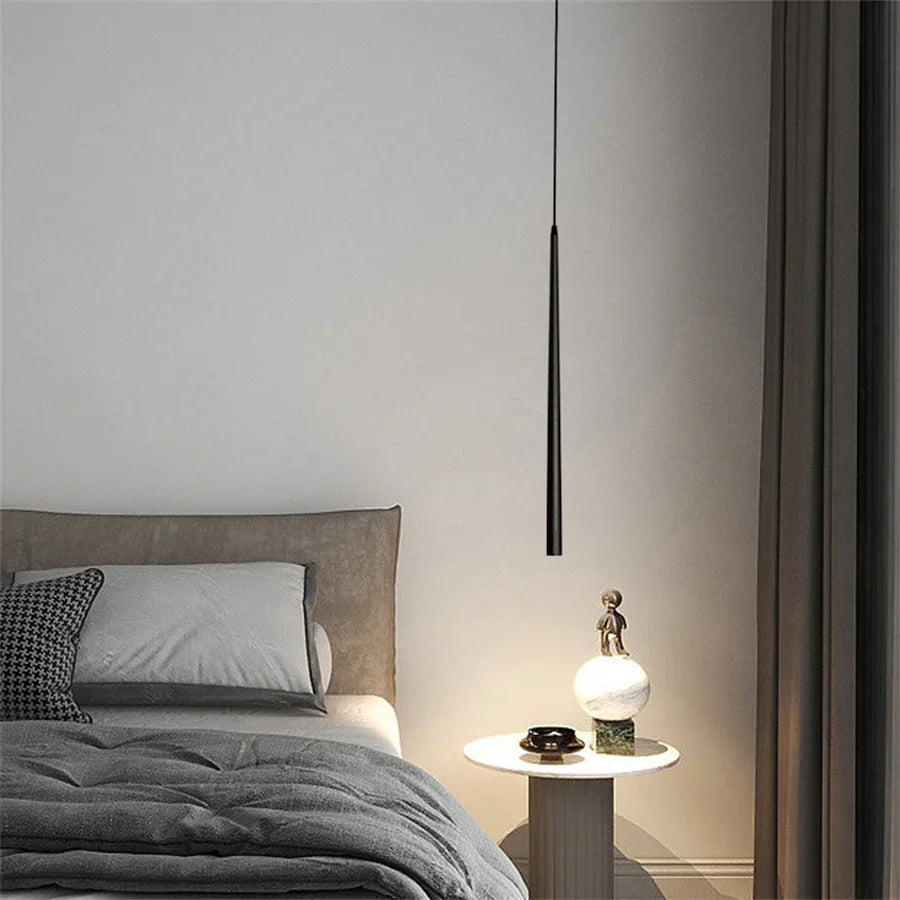 Modern cone LED pendant light hanging above a kitchen island in a contemporary home.