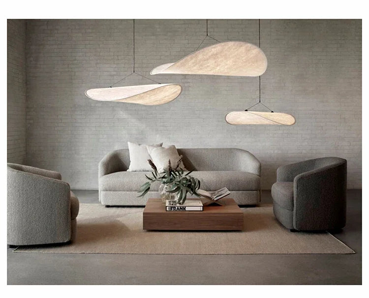 Nordic modern LED pendant light hanging above a dining table in a contemporary living room.