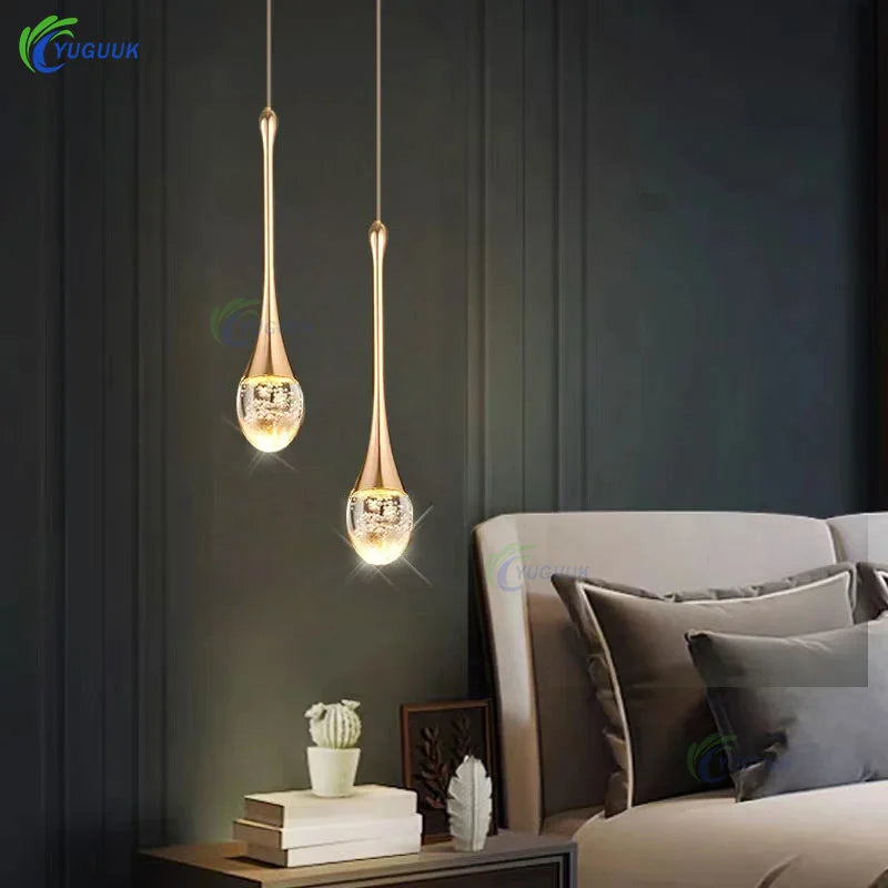 Modern bubble crystal pendant light hanging above a kitchen island in a luxury contemporary home.