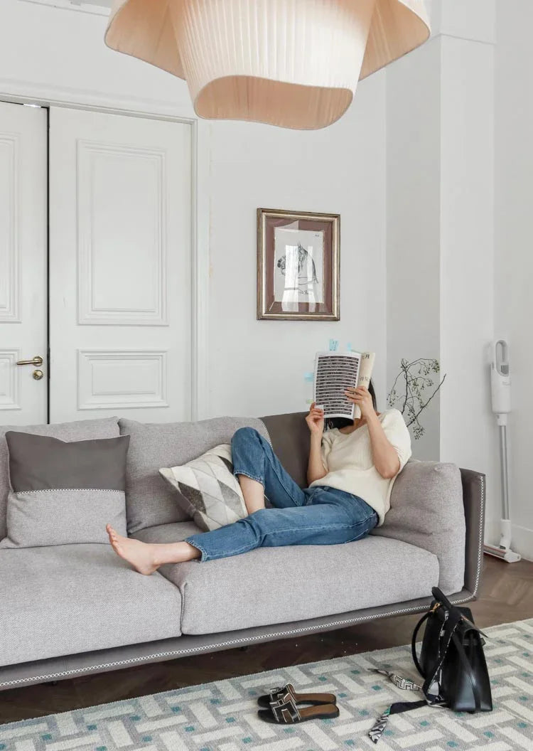 Nordic modern LED pendant light hanging above a dining table in a contemporary living room.