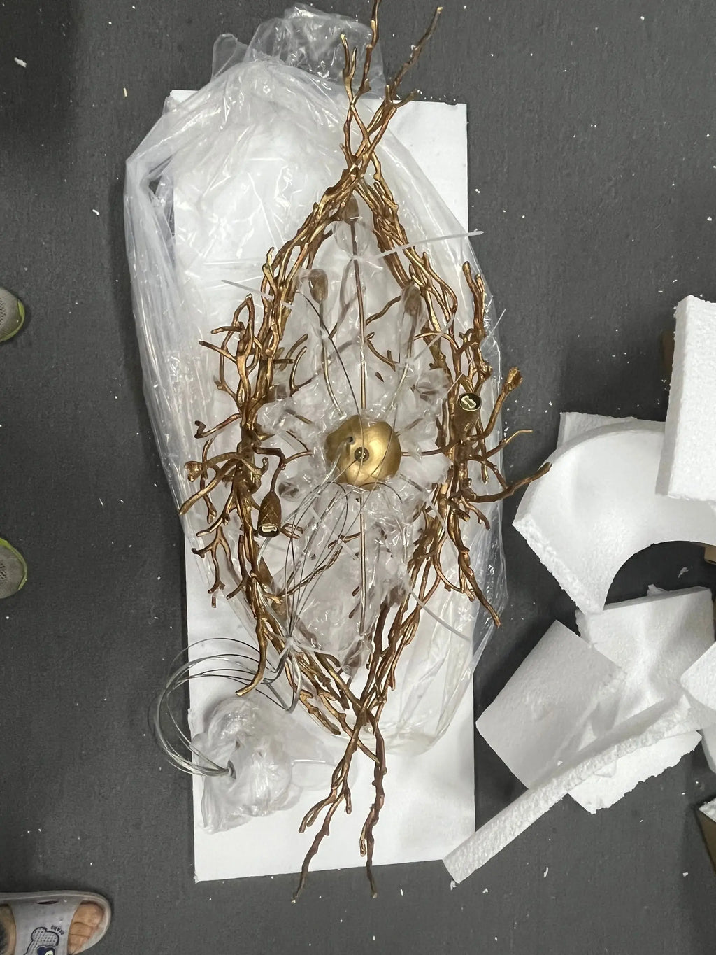 Luxury gold branch crystal chandelier hanging in a modern living room with elegant contemporary décor.