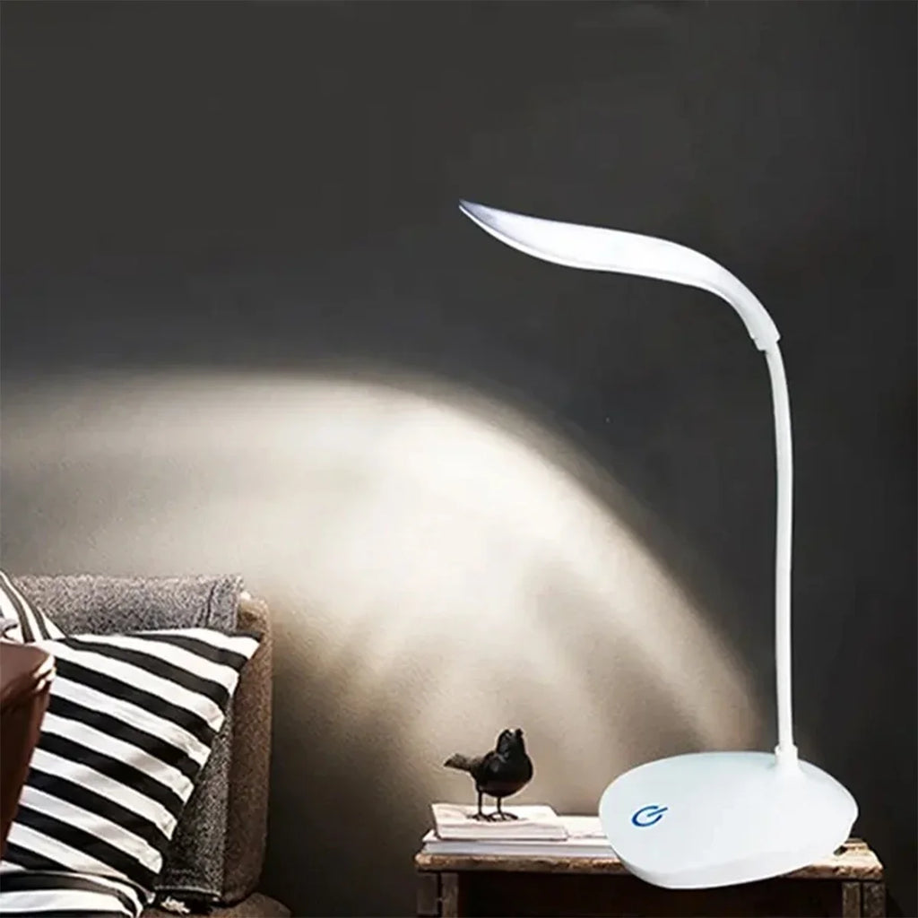 Modern LED eye care desk lamp with USB charging and touch dimming on a study desk.