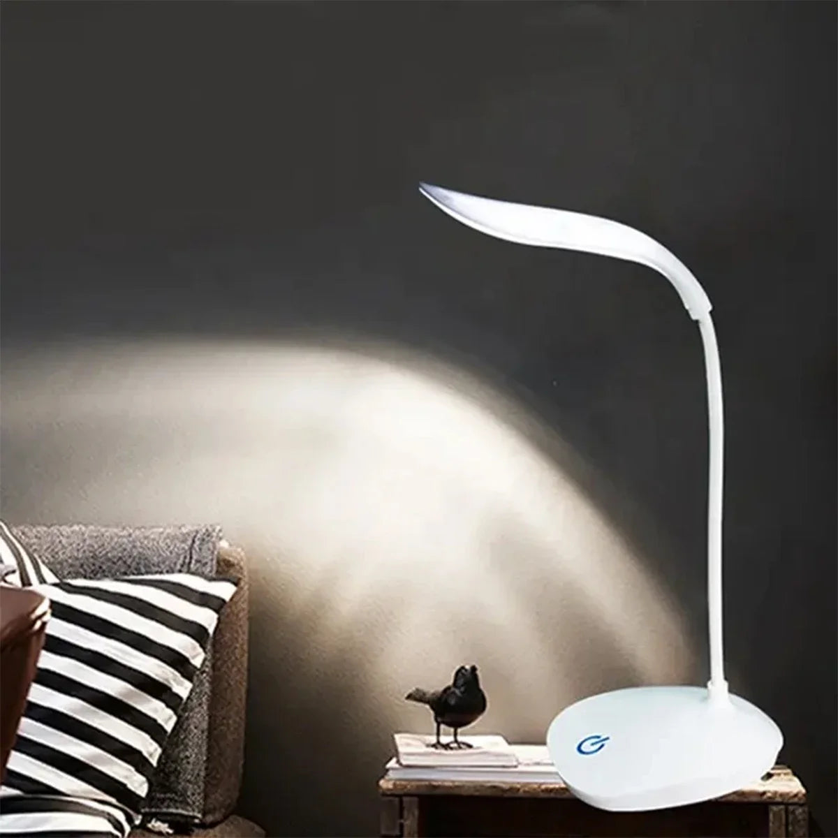 Modern LED eye care desk lamp with USB charging and touch dimming on a study desk.