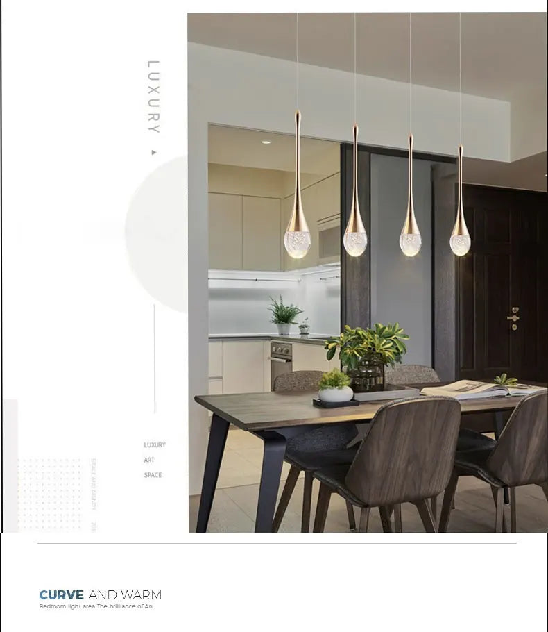 Modern bubble crystal pendant light hanging above a kitchen island in a luxury contemporary home.