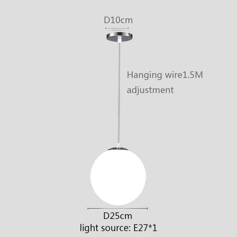 Modern glass globe pendant light with gold finish hanging above a contemporary dining table.