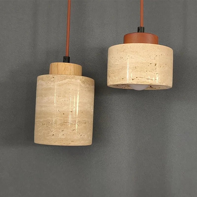 Wabi-Sabi Japanese pendant light with a natural stone-inspired shade hanging beside a modern bed.