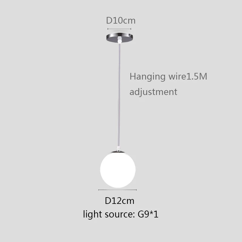 Modern glass globe pendant light with gold finish hanging above a contemporary dining table.
