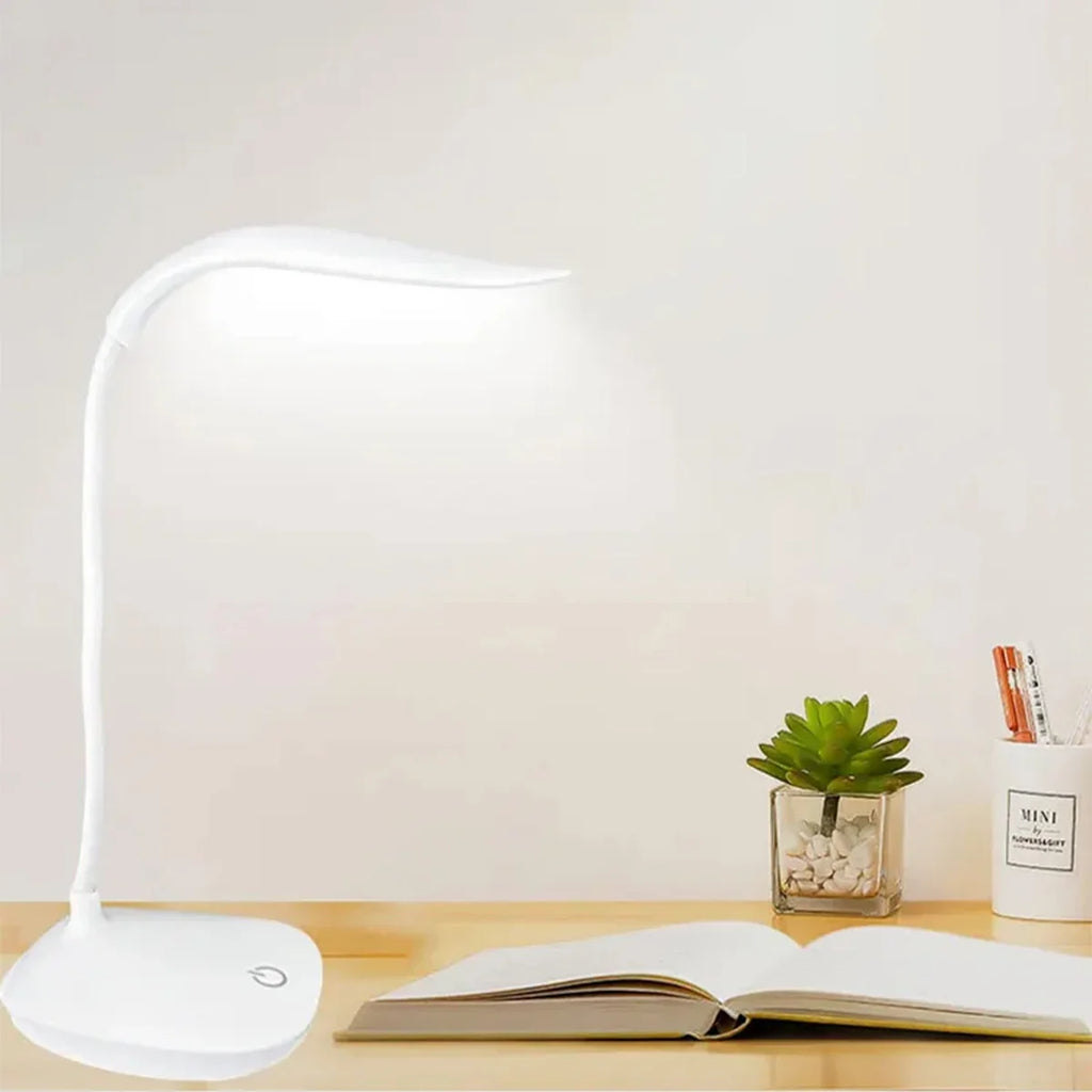 Modern LED eye care desk lamp with USB charging and touch dimming on a study desk.