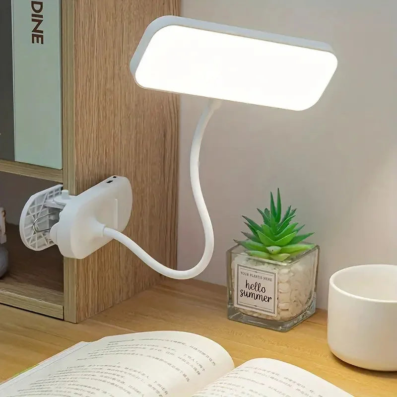 Rechargeable LED clip-on desk lamp attached to a study desk for reading and office work.
