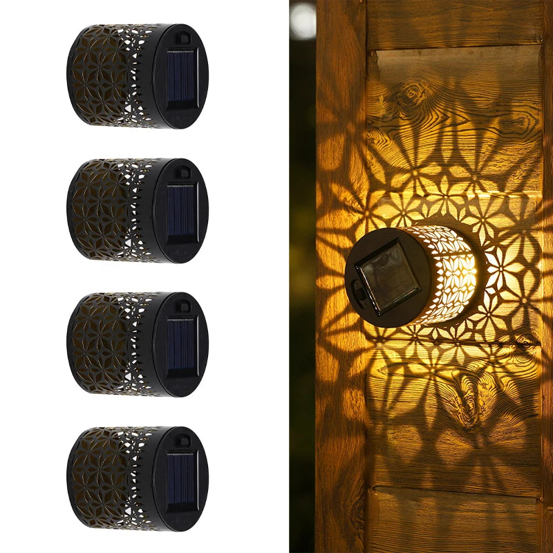 Modern waterproof solar projection LED wall light casting a decorative light pattern on an outdoor garden wall.