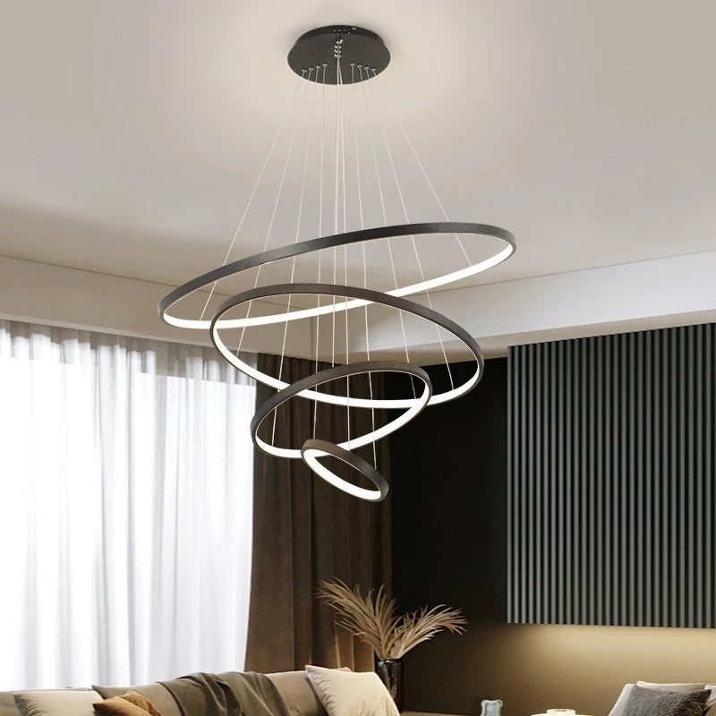 Modern LED ring chandelier suspended above a dining table in a luxury contemporary home.