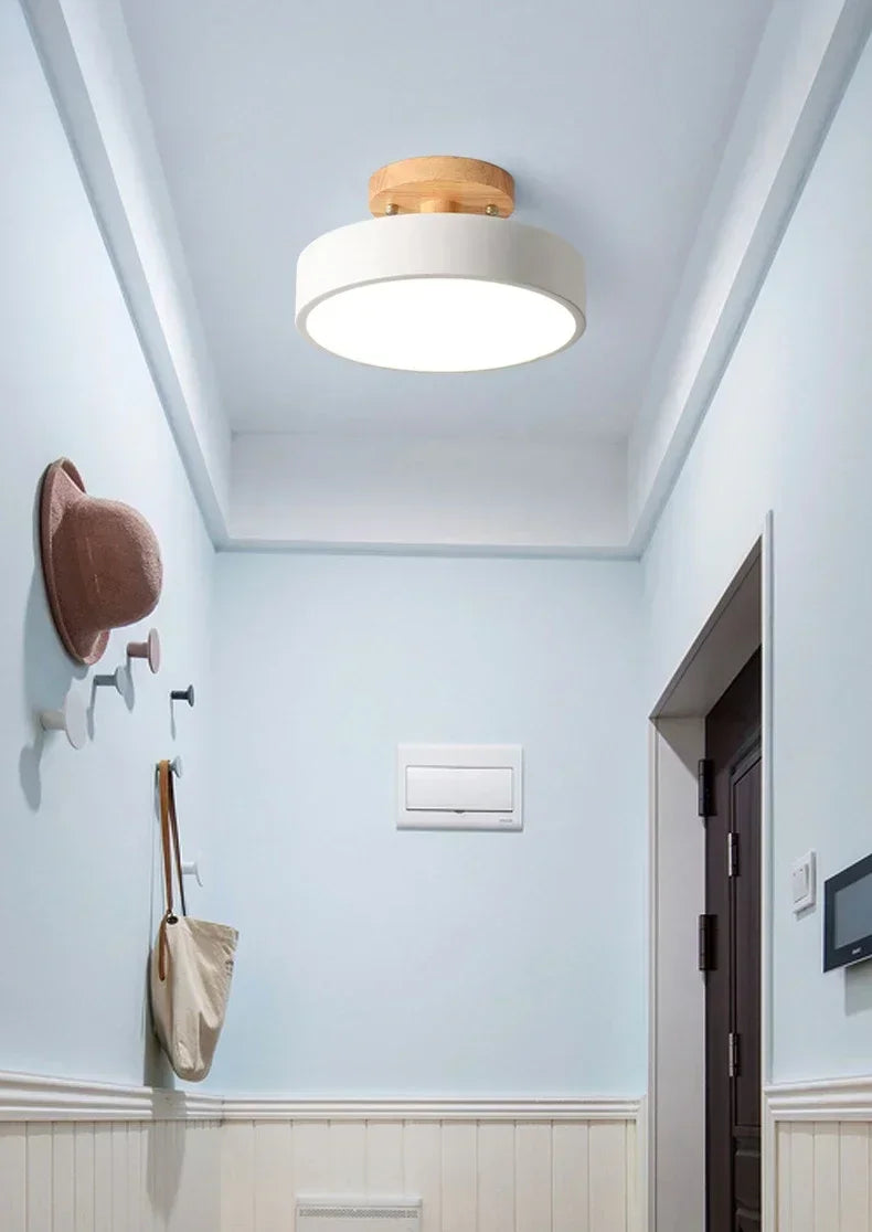 Nordic wood round LED ceiling light installed in a modern hallway with Scandinavian-inspired interior décor.