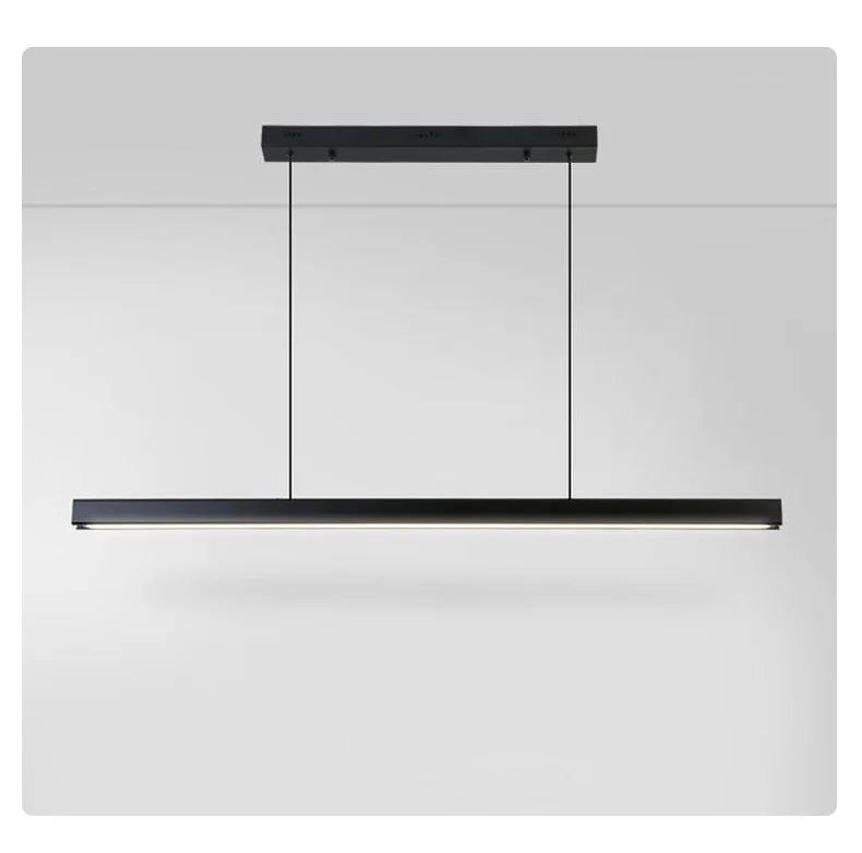 Modern linear LED pendant light suspended above a dining table in a contemporary dining room.