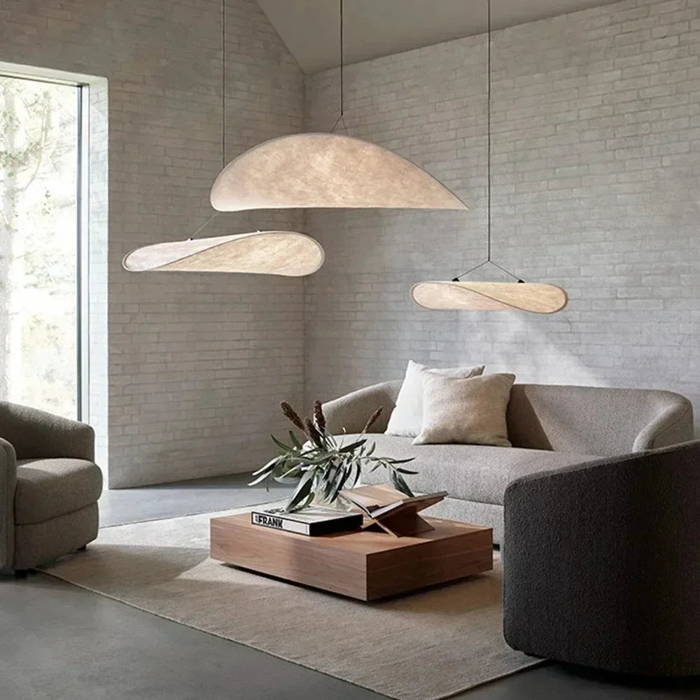 Nordic modern LED pendant light hanging above a dining table in a contemporary living room.