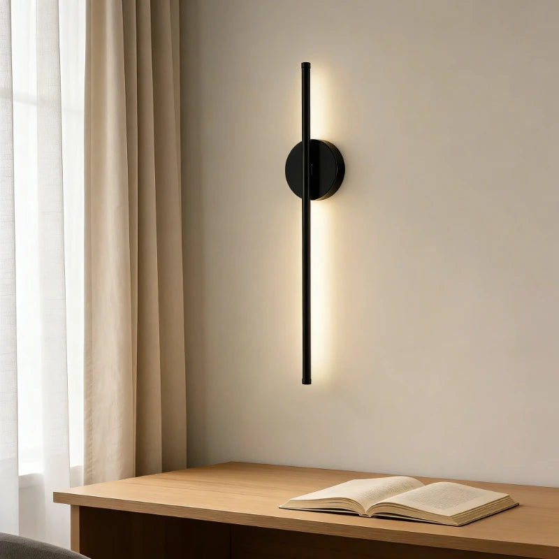 Wireless rechargeable LED wall sconce with remote control mounted beside a modern bedroom bed.
