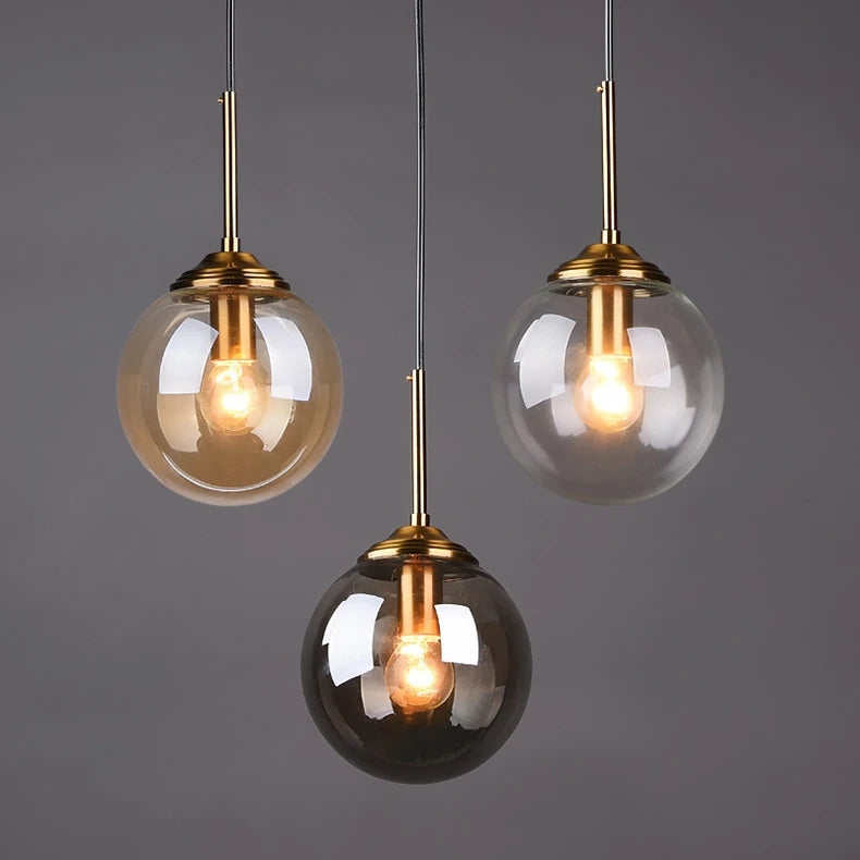 Modern luxury glass LED pendant light hanging above a dining table in a contemporary home.