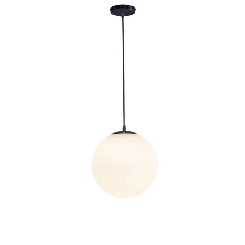 Modern Glass Globe Pendant Light hanging from ceiling in a stylish dining room setting.