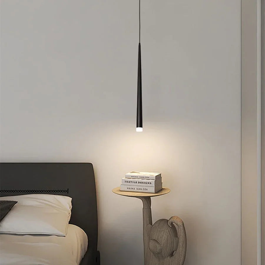 Modern cone LED pendant light hanging above a kitchen island in a contemporary home.