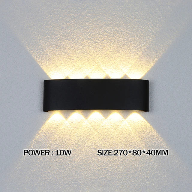 Modern waterproof LED wall light installed on an exterior house wall illuminating a porch and garden.